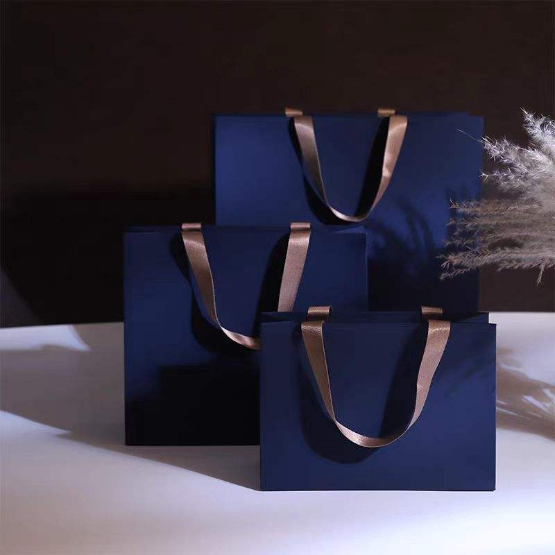 Luxury white boutique shopping bag with embossed logo and black handles